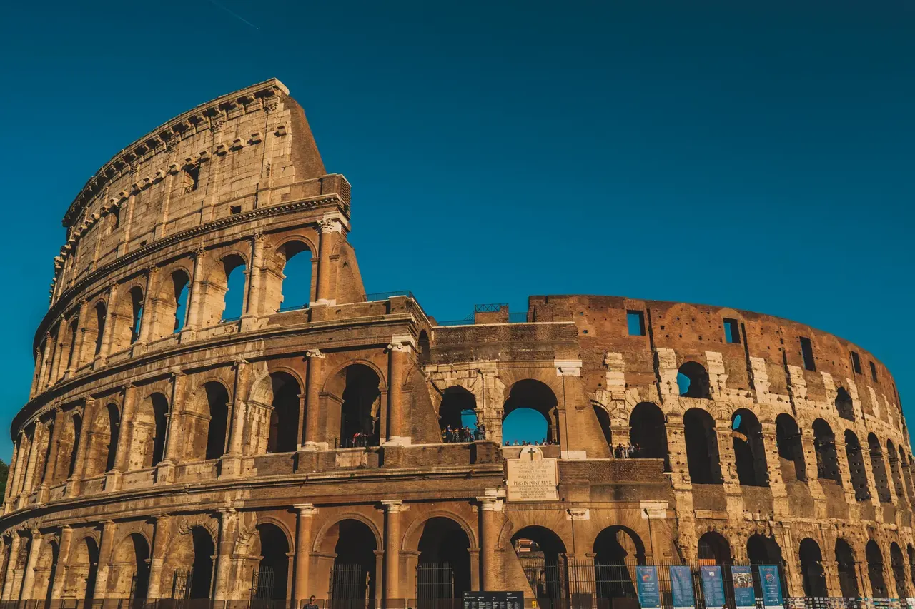 The arches of the Colosseum in Rome at sunset