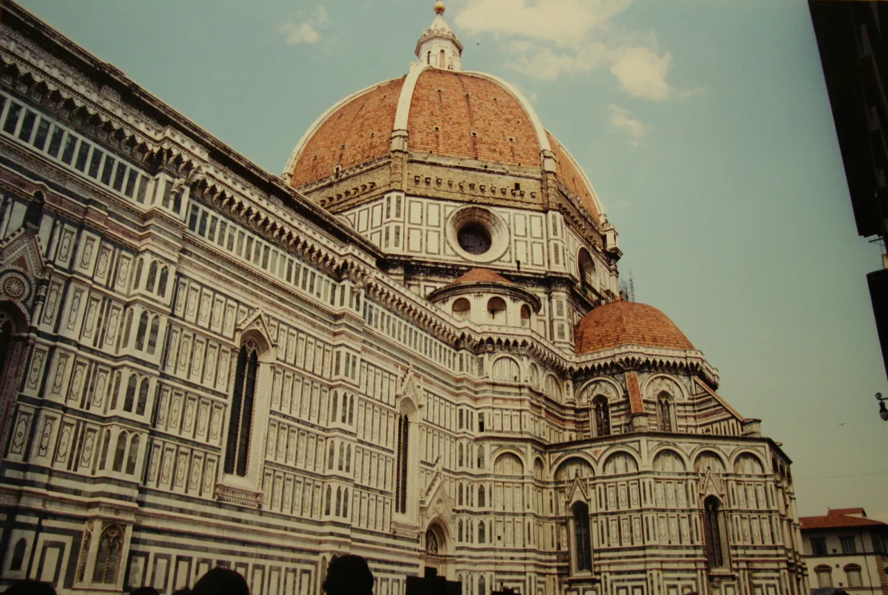 Brunelleschi's dome and the marble facade of Florence Cathedral seen from the square