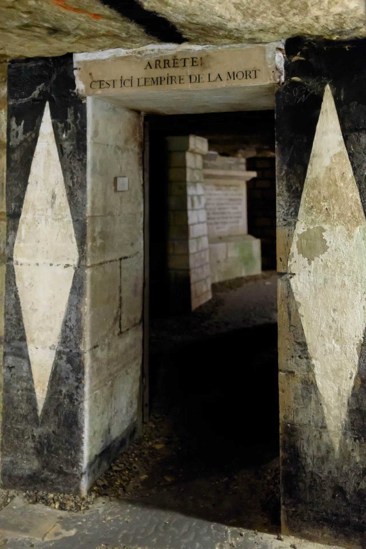 The stone threshold in the Paris Catacombs marked Arrête! C’est ici l’empire de la mort