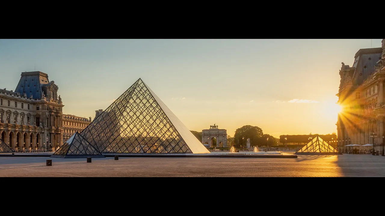 The Louvre pyramid at sunset in Paris