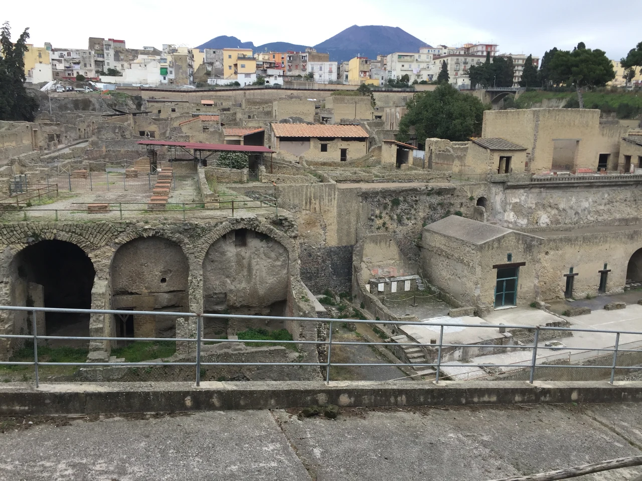 Roman buildings and excavated streets at Herculaneum, with modern Ercolano beyond