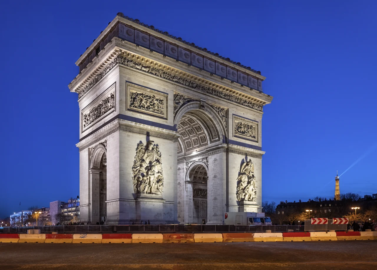 The Arc de Triomphe illuminated against the night sky in Paris