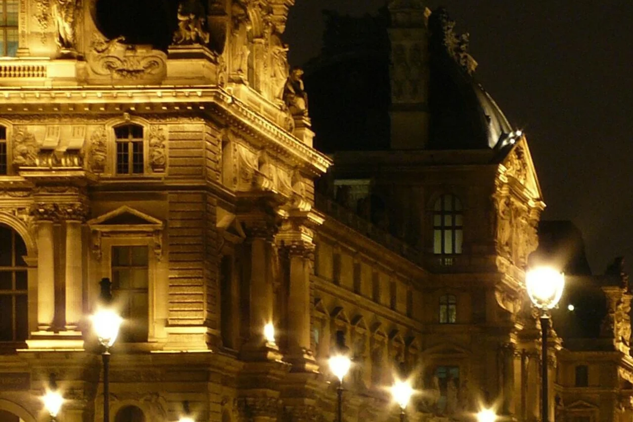 The historic facade of the Louvre palace illuminated at night