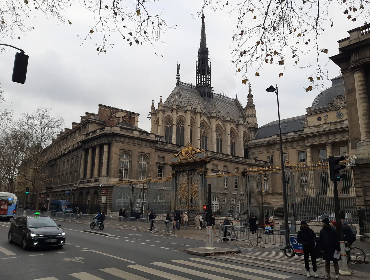 The Gothic exterior and spire of Sainte-Chapelle seen from a Paris street