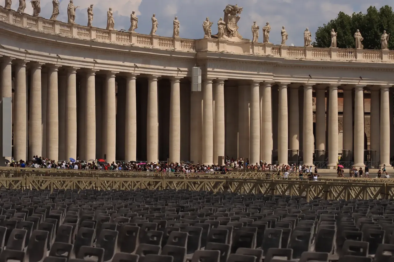 The colonnade and visitors in St Peter’s Square, Vatican City